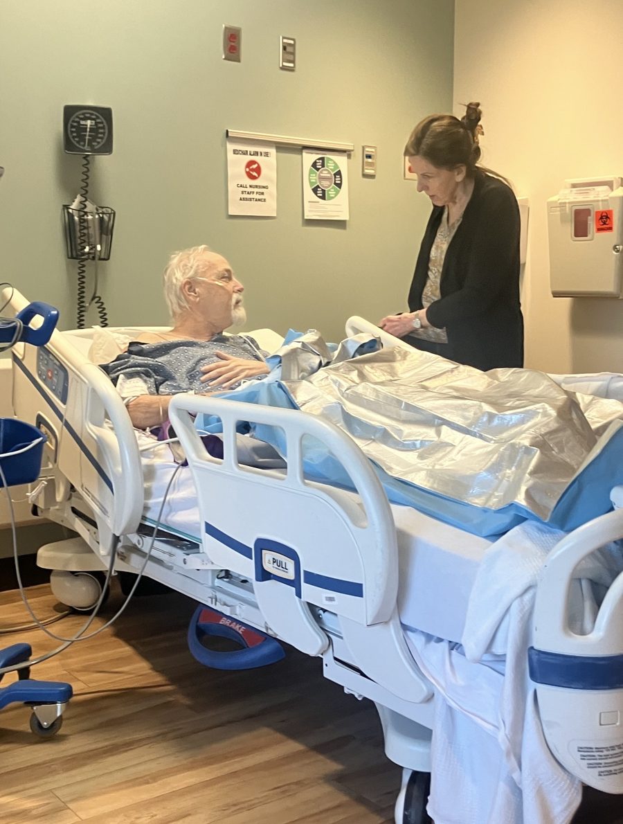 Brian in his hospital bed talking with Charlotte